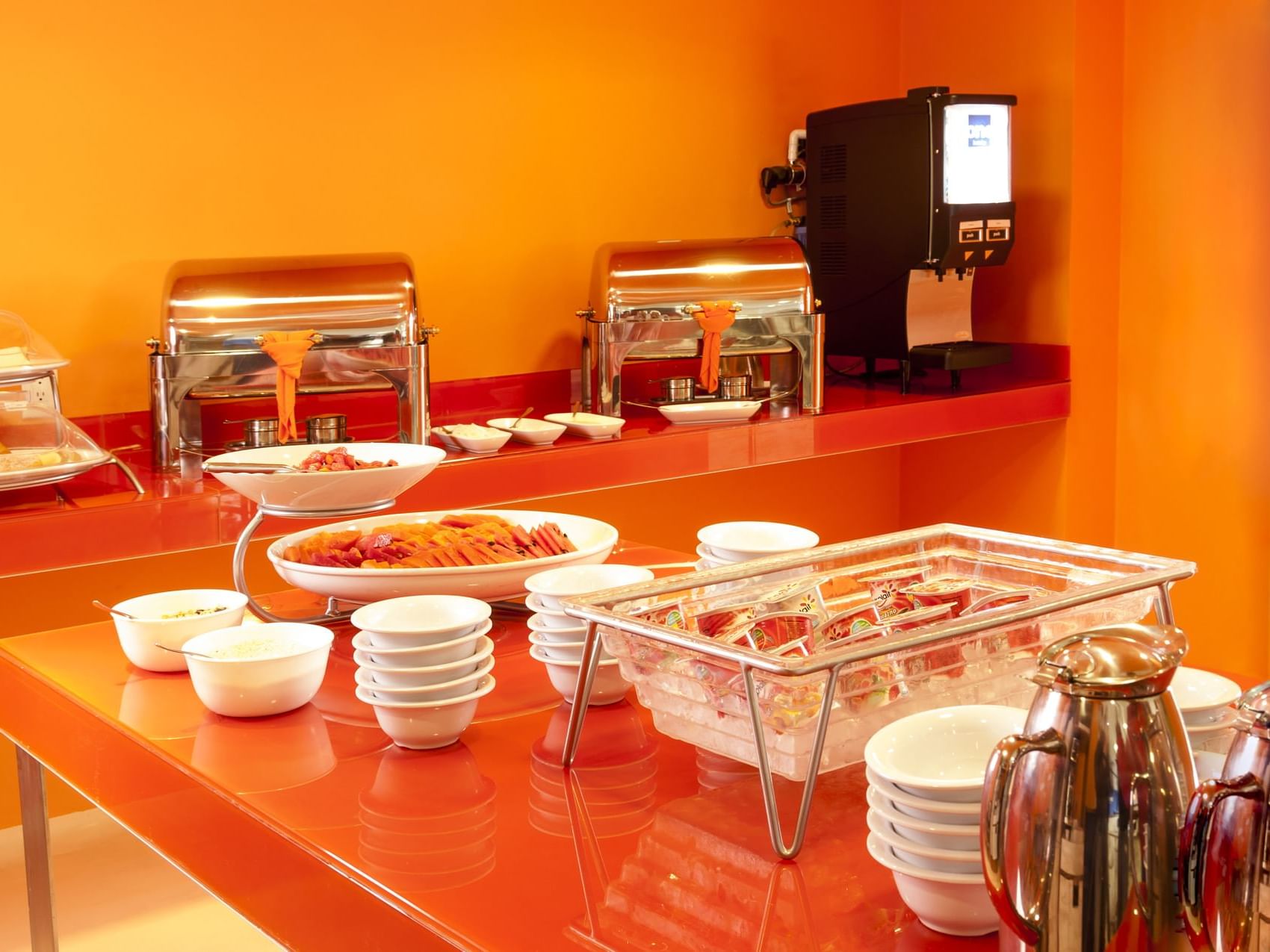Breakfast buffet with a coffee dispenser at One Hotels