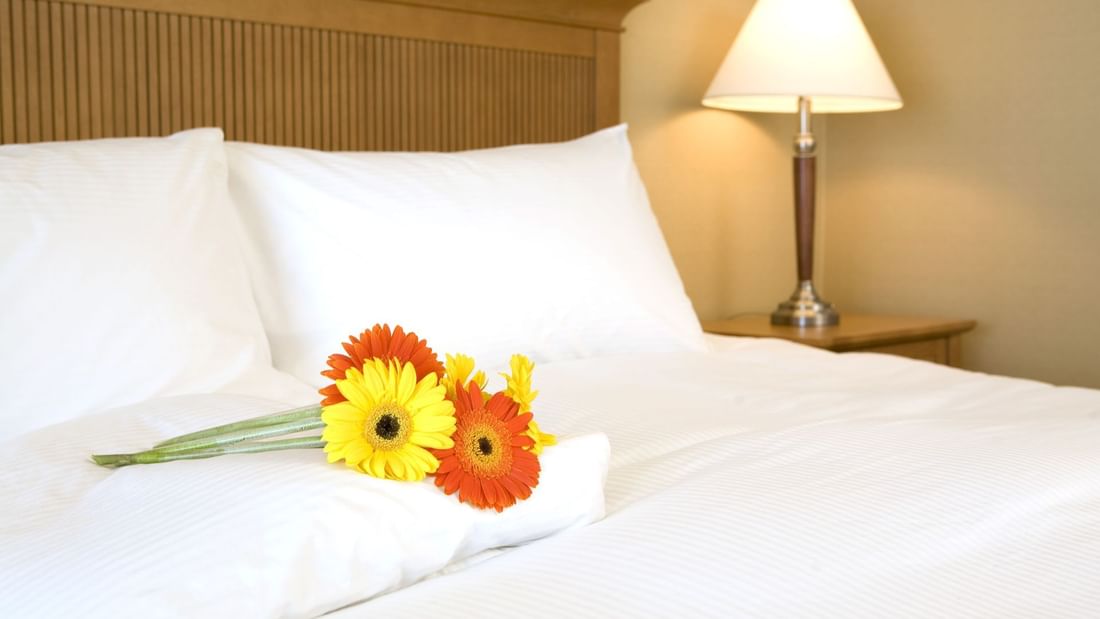 Yellow and orange flowers on hotel bed