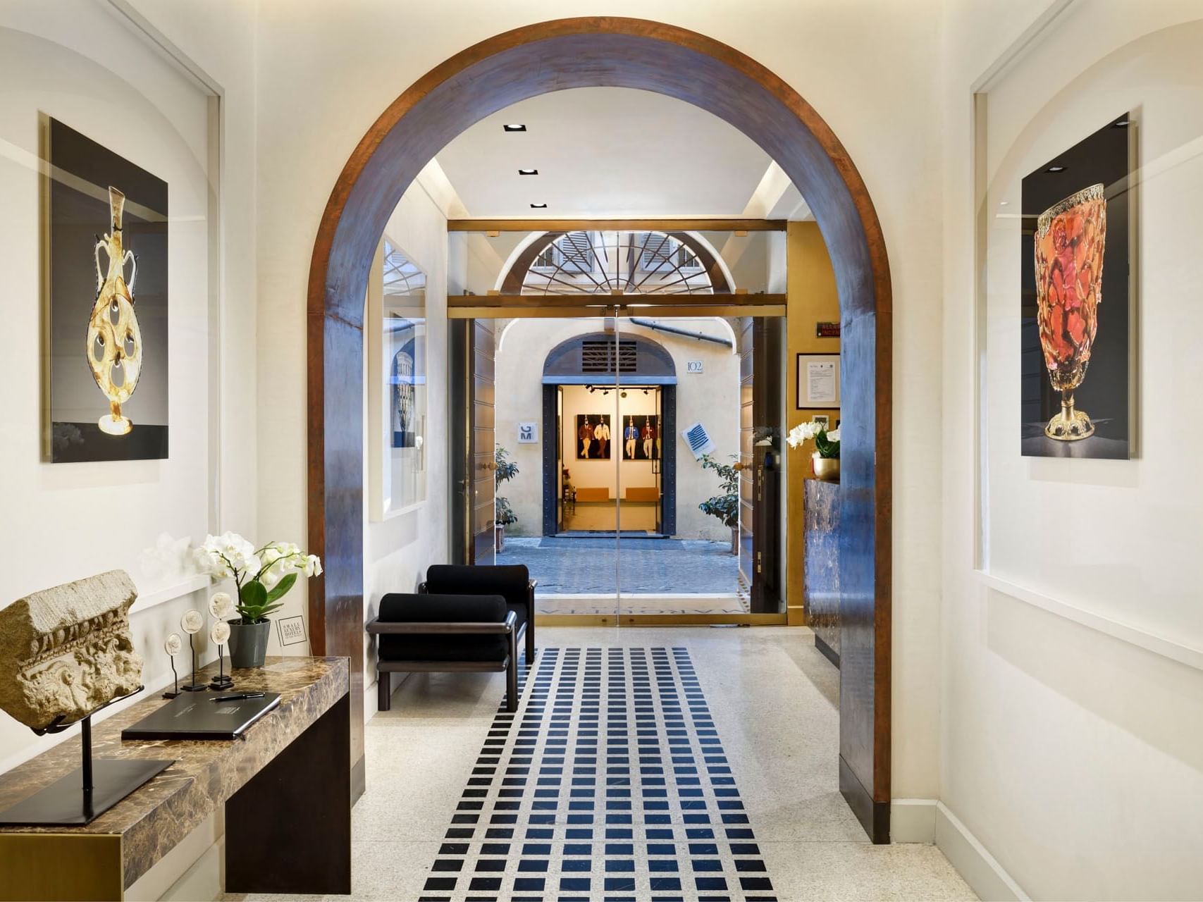 Illuminated hallway with loungers and wall art at Margutta 19