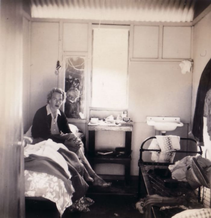 Old photo of a lady sitting in a bedroom at Heron Island Resort