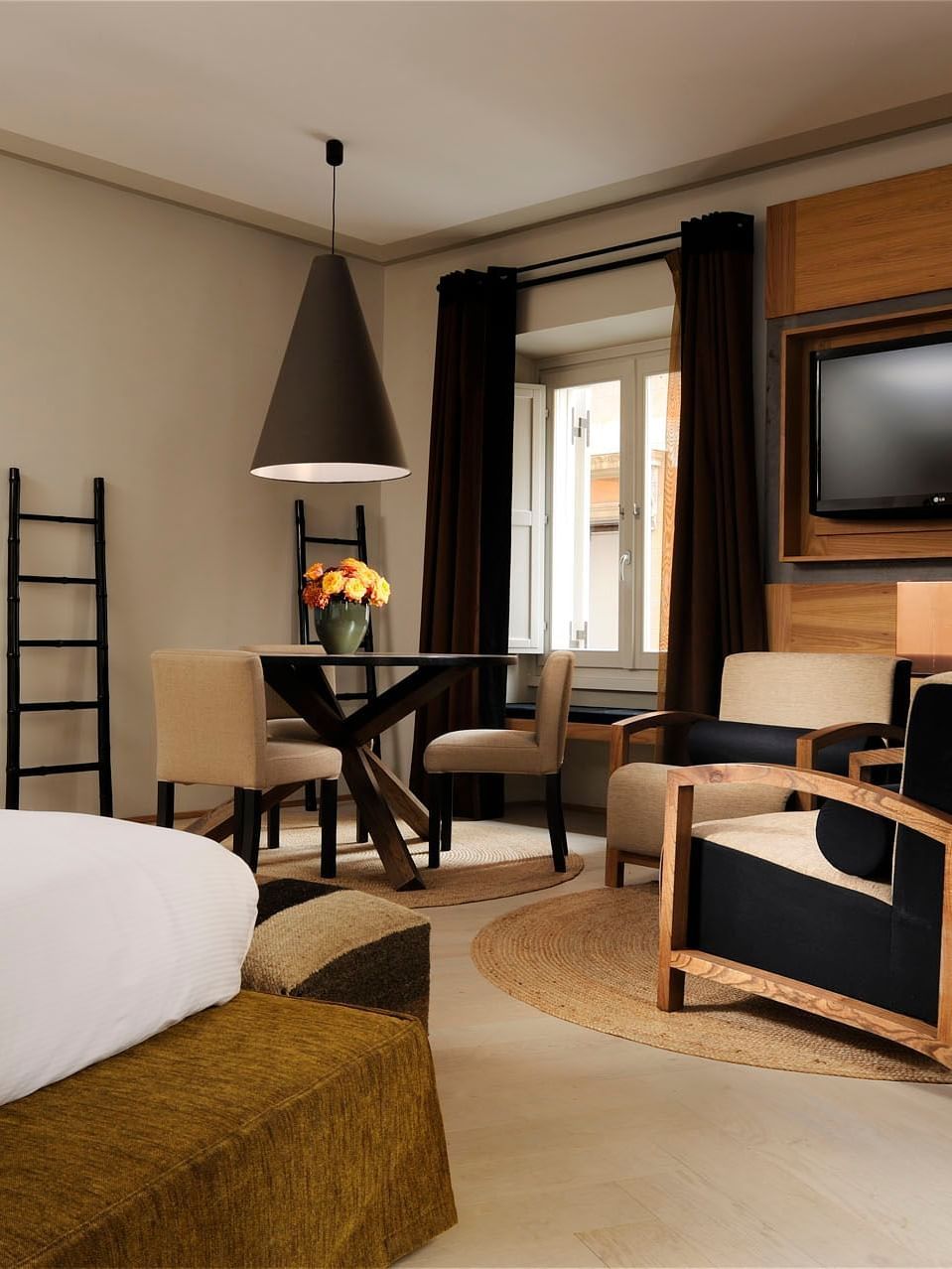 Large bed, a seating area, wooden decor and a TV in Deluxe Suite at Babuino 181