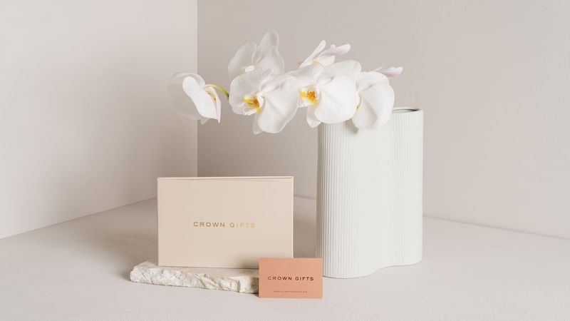 Orchids in a vase with elegant packaging boxes on a neutral background at Crown hotels Perth