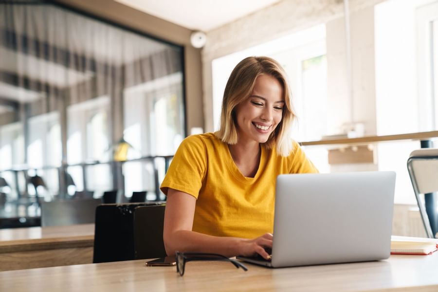 A lady working on her laptop at The Originals Hotels