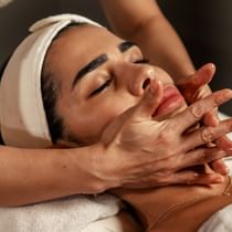 A lady receiving a facial in the spa at Palazzo Versace Dubai
