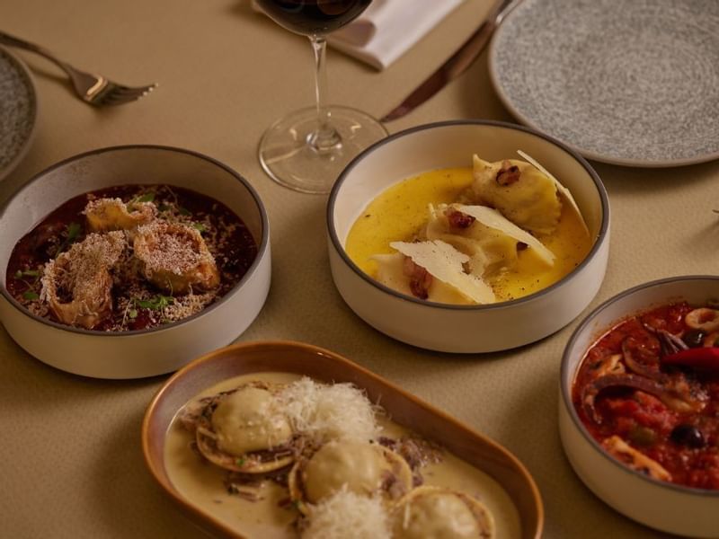 Dining setup with various gourmet pasta dishes in Modo Mio at Crown Promenade Perth