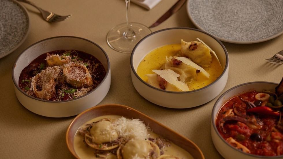 Dining setup with various gourmet pasta dishes in Modo Mio at Crown Promenade Perth