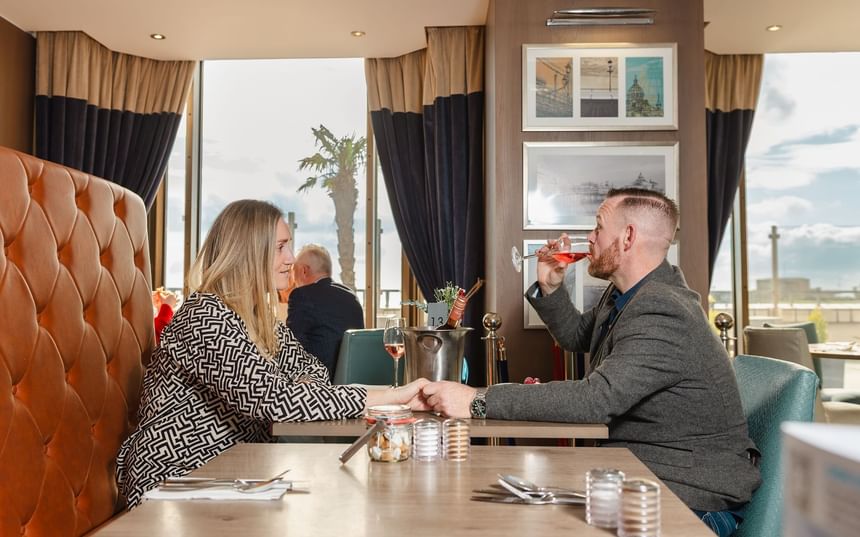 Two guests enjoying a drink in the dining area at The View Hotel Eastbourne