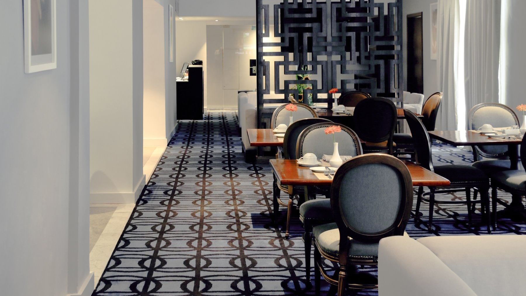 Dining tables arranged in a dining hall at Gamma Hotels