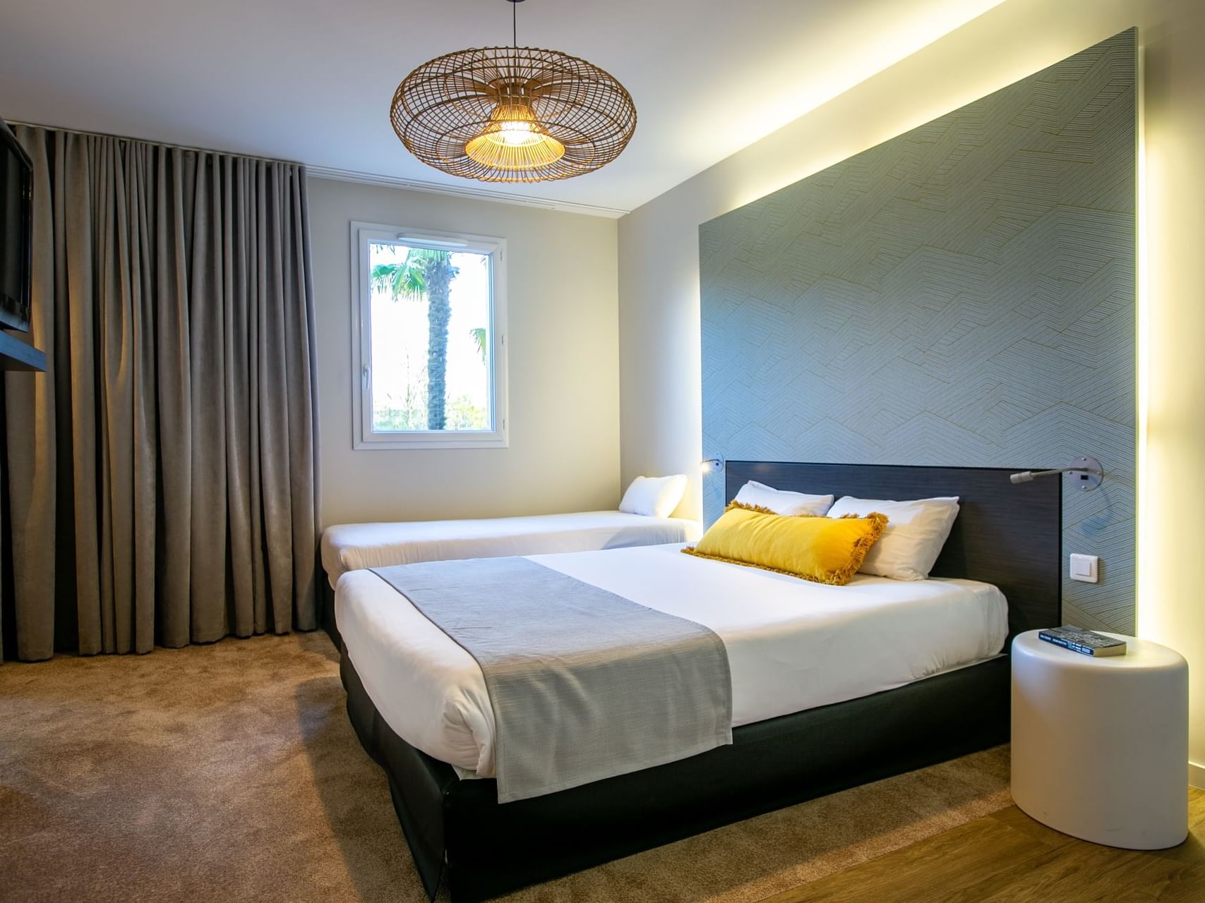 Single bed by the King bed in PMR Comfort Room with a warm ambience at Hotel Saint James