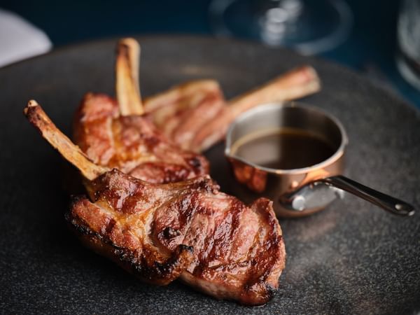Close-up of The Lamb Cutlets served in the Restaurant at The Capital Hotel London