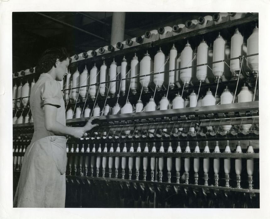 Black & white image of a lady in a factory near Hotel Moco