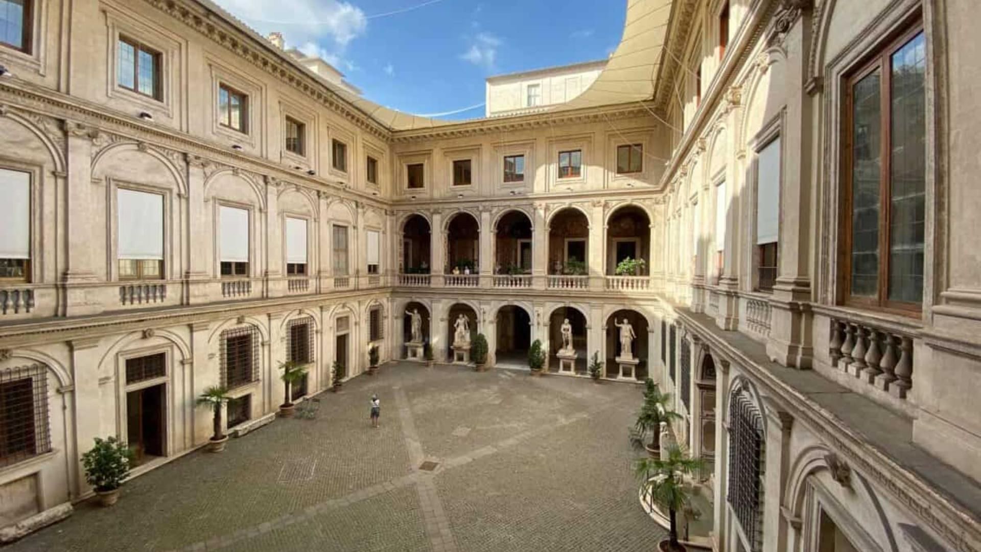 Courtyard with numerous windows and arches in Palazzo Altemps museum near Rome Luxury Suites