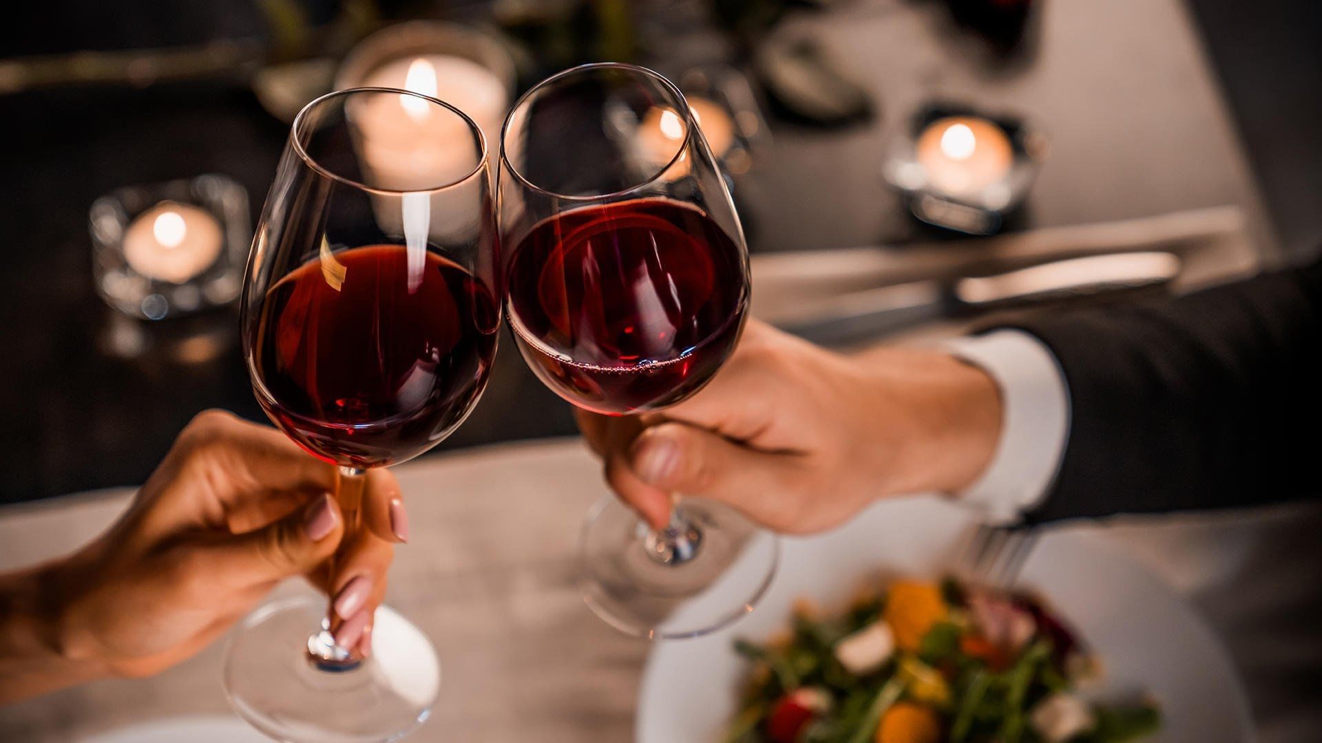 A couple toasting with wine at Live Aqua Urban Resort Monterrey