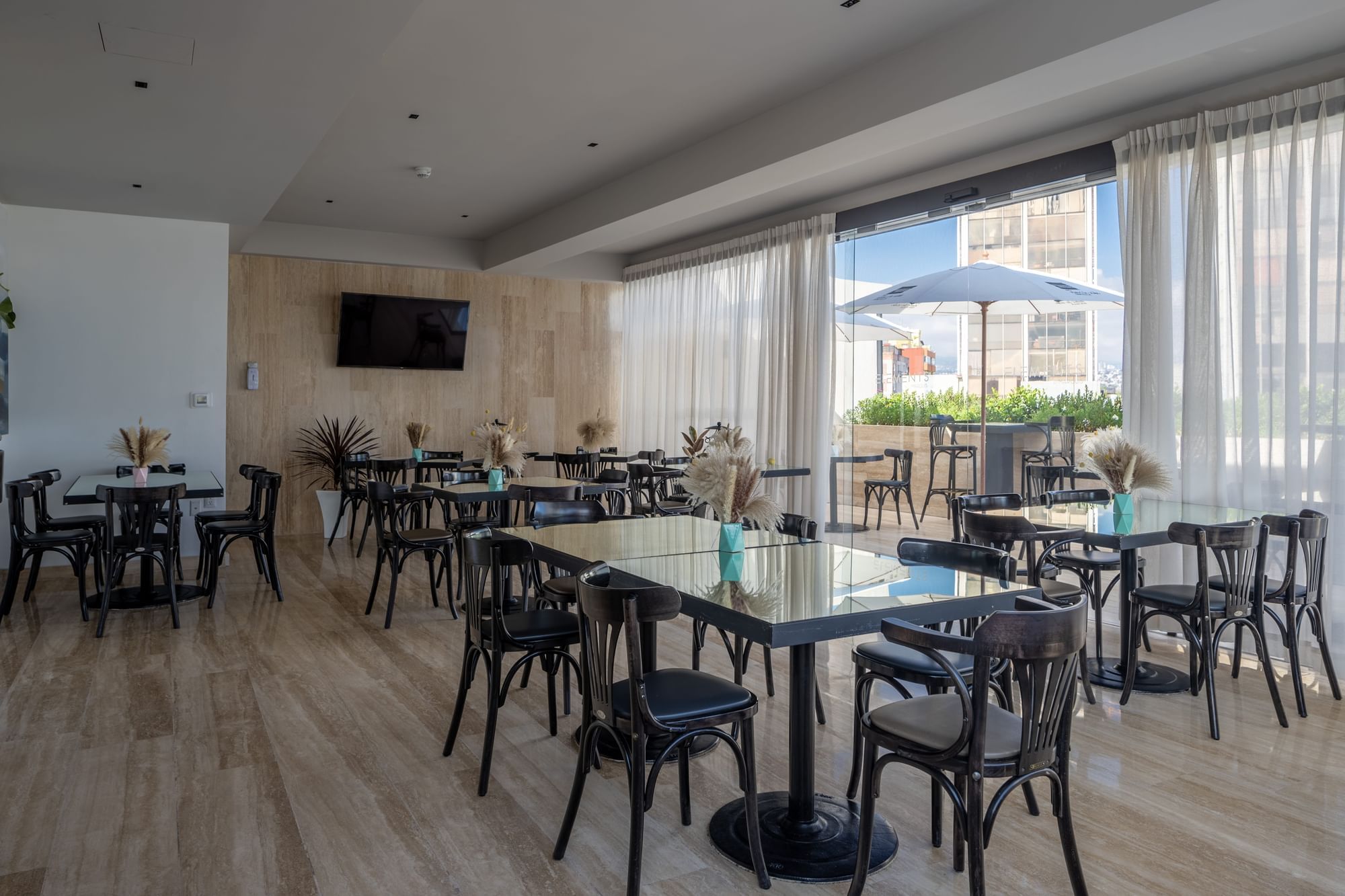 Interior of the Elements by Marquis restaurant with an outdoor seating area.