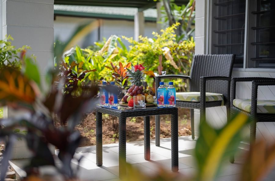 Tropical patio with table, chairs, and fresh fruits at Tokatoka Resort Fiji International Airport.