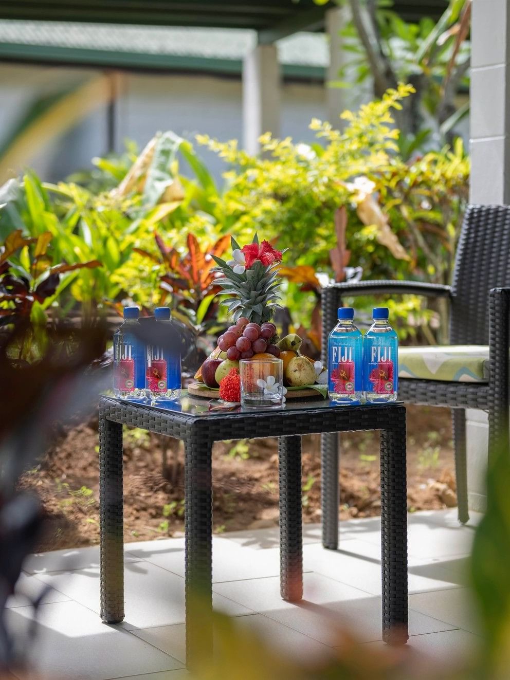 Outdoor patio table with fruits and beverages at Tokatoka Resort - Fiji International Airport, Nadi.