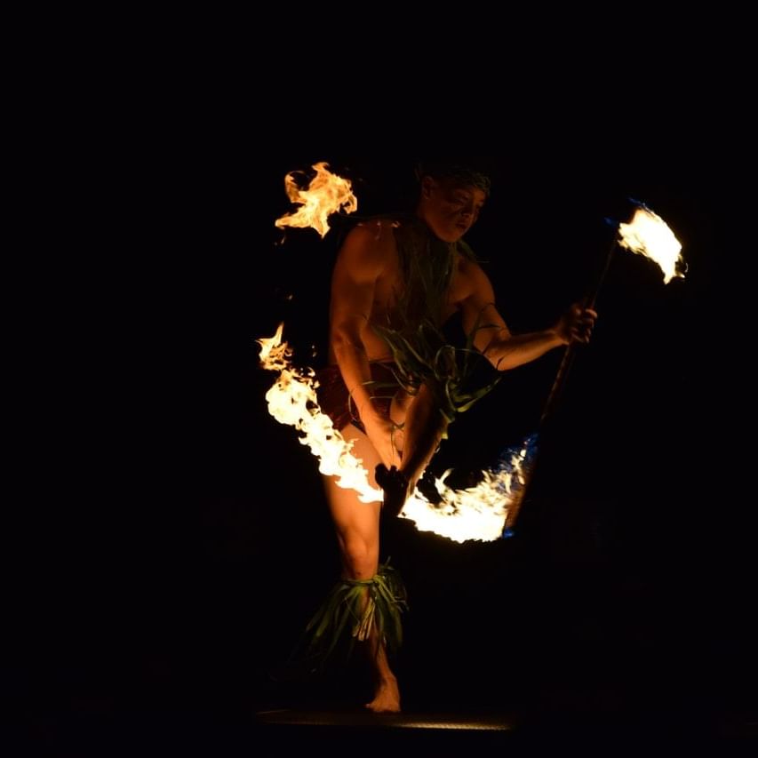 Fire dancer performing in the dark near Waikiki Resort Hotel by Sono
