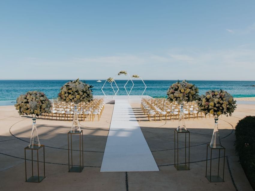 Beautiful outdoor wedding ceremony setup on a patio overlooking the ocean at Marquis Los Cabos Resort.