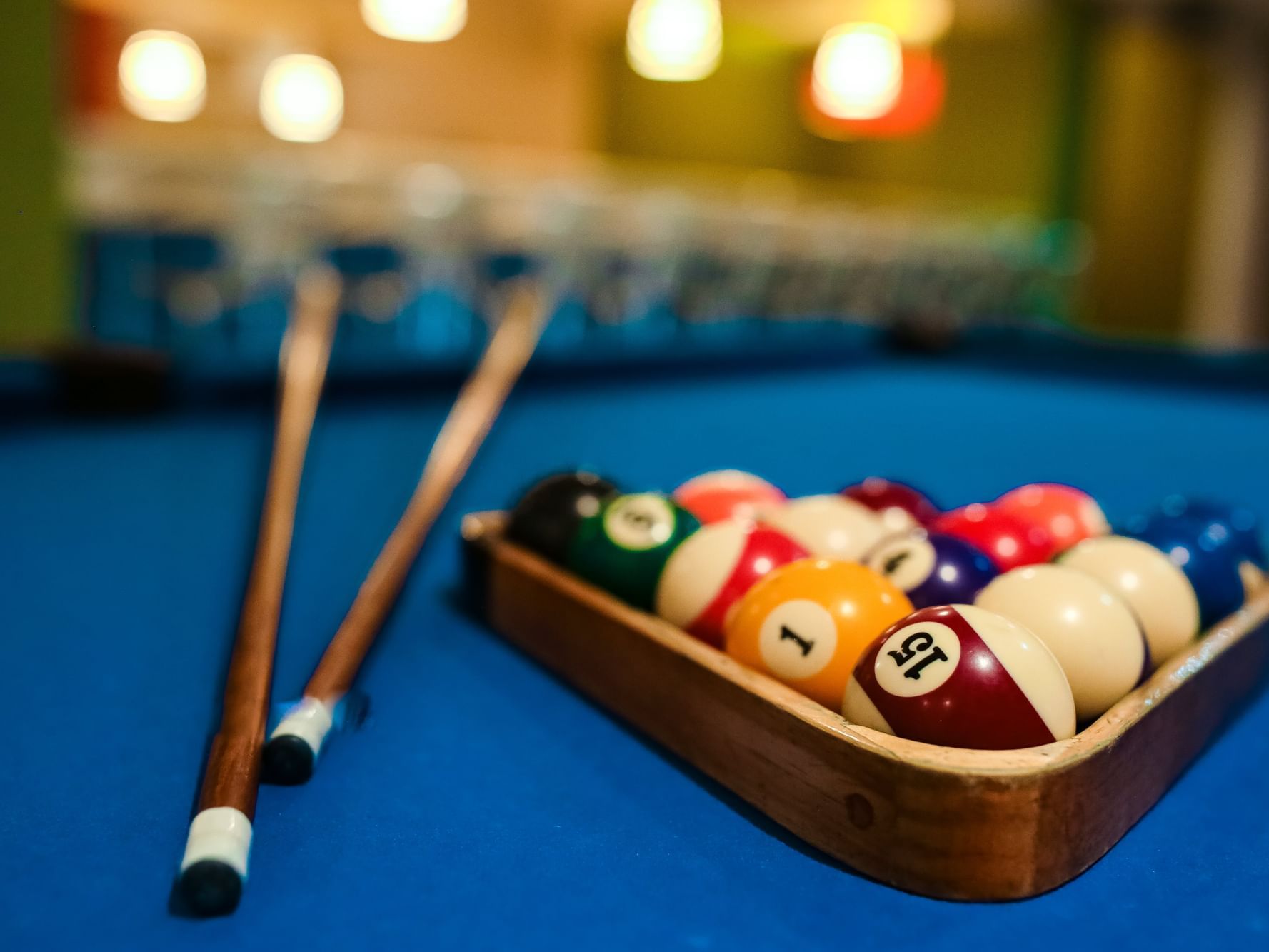 Close-up of a pool table with cue balls in Teens Zone at Fiesta Resort