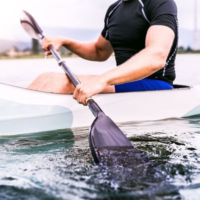 Close-up of a man paddling near Falkensteiner Hotels