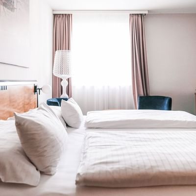 Large bed in Superior Room at Falkensteiner Hotels