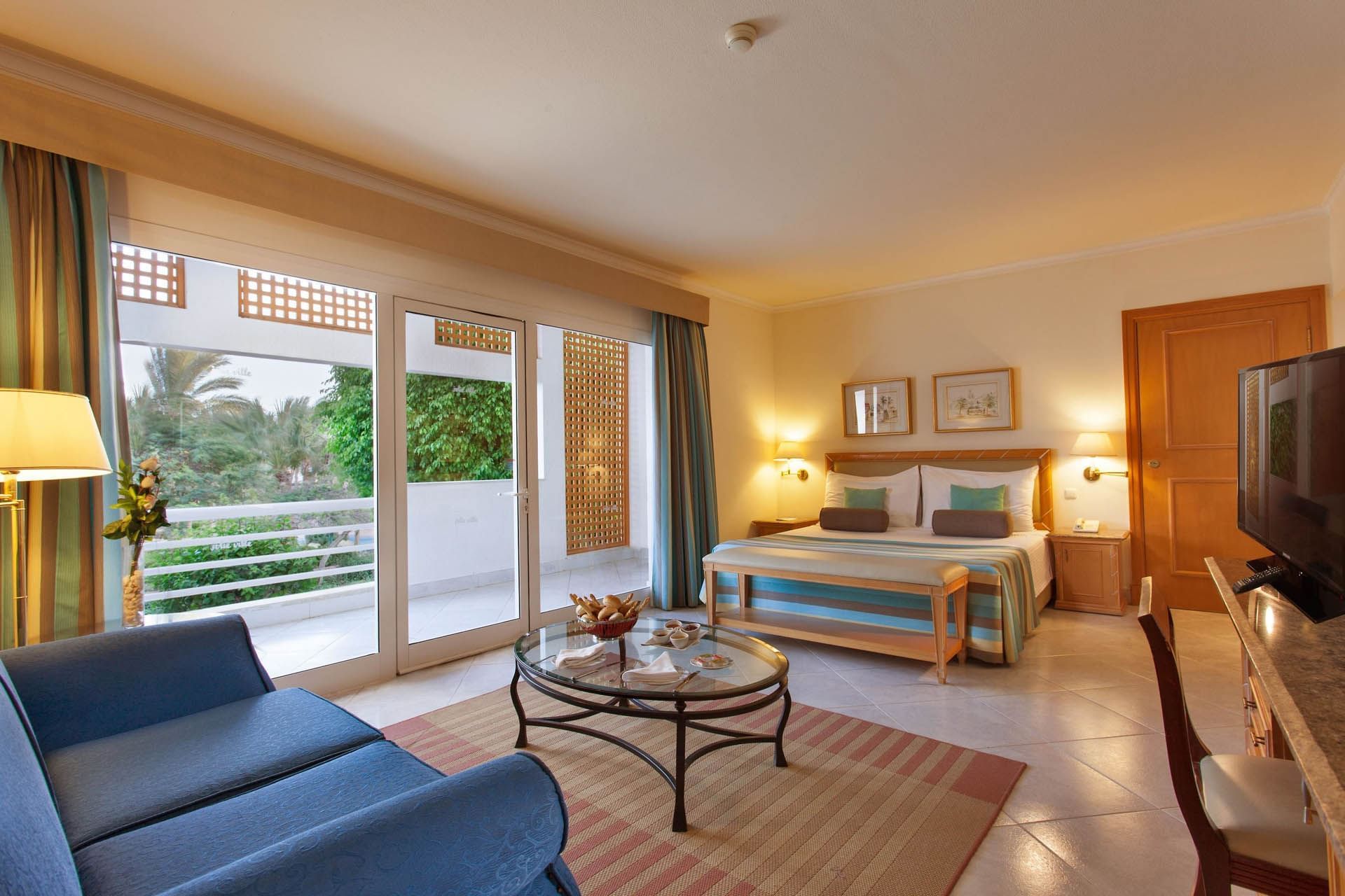 Bright Seaview Superior Room at Pickalbatros Golf Beach Resort with a bed, sitting area, garden view, and a stylish ambience
