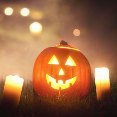 Carved pumpkin with glowing face at Haunted Halloween Bash near Falkensteiner Club Funimation Borik