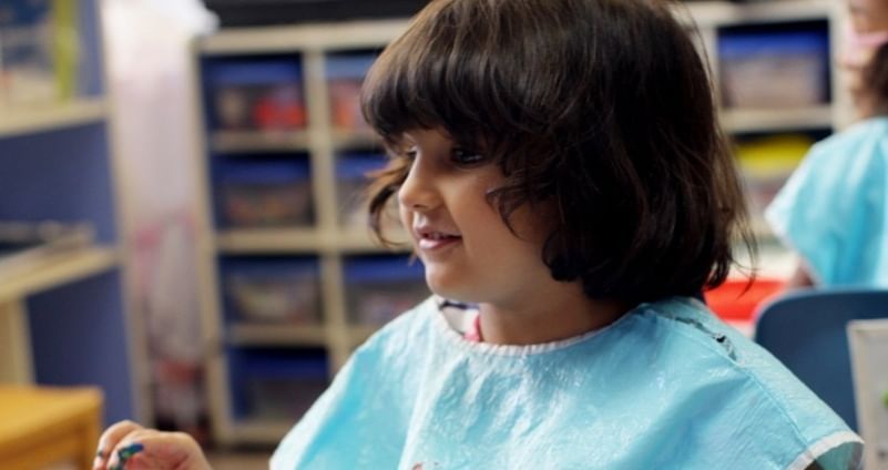 A kid at a painting class.