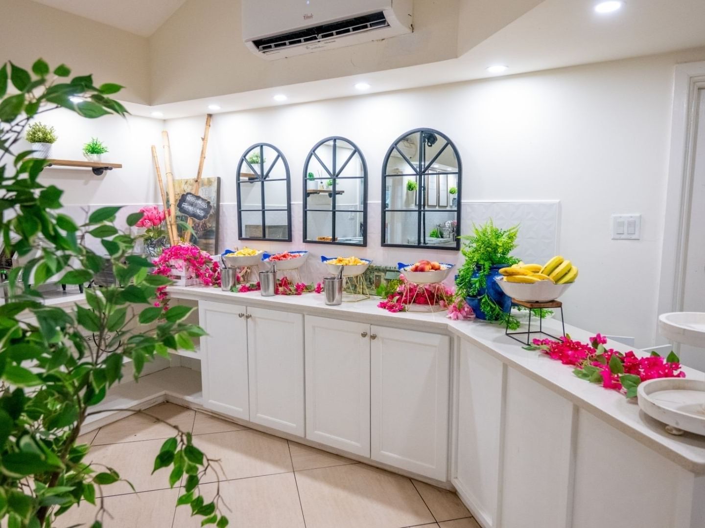 White kitchen counter with fruits and flowers at Savannah Beach Hotel.
