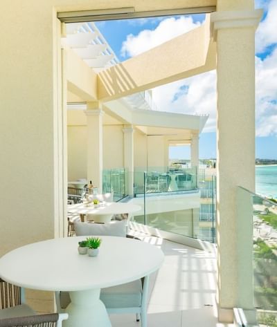 Bright balcony with a dining table in Five Bedroom Beachfront Penthouse Suite with Skypool at Windsong Resort On The Reef