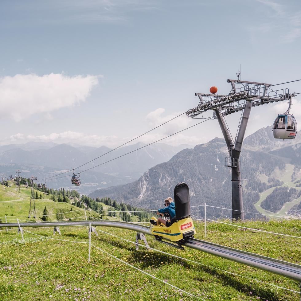 Kid on Toboggan ride on a hill near Falkensteiner Hotels