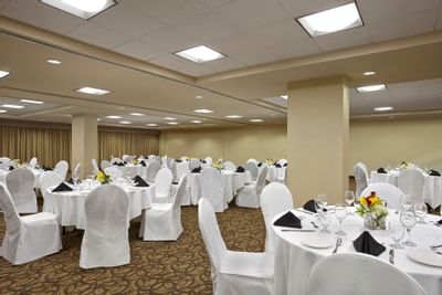 Banquet-style tables set up in an Airport Wedding venue at Acclaim Hotel Calgary