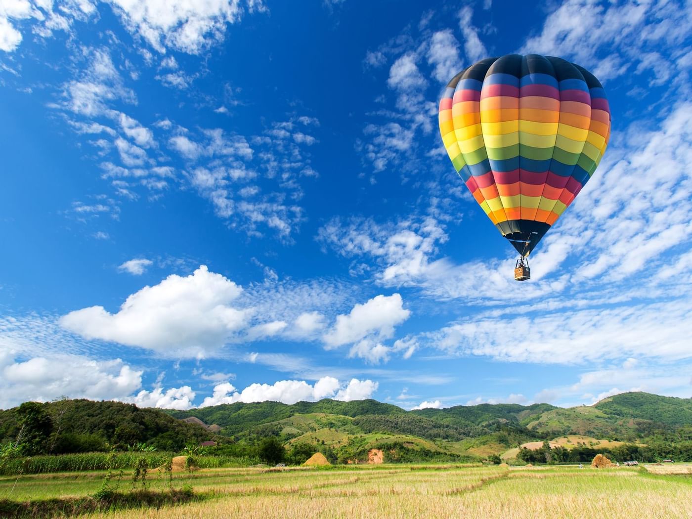 Hot air balloon ride in blue sky near Grand Fiesta Americana