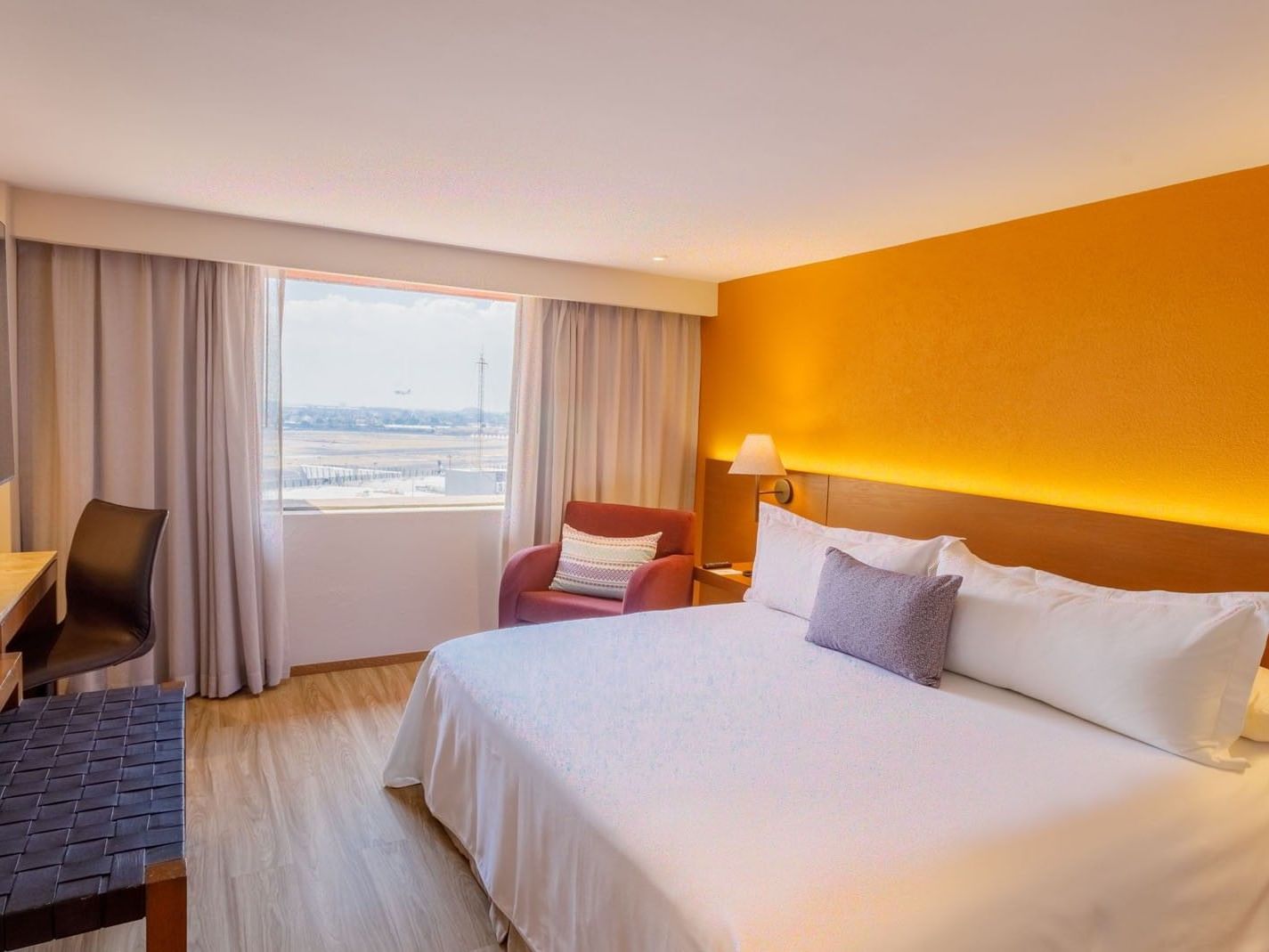 King Deluxe Superior room featuring a large bed with a couch by the window at Camino Real Aeropuerto Mexico