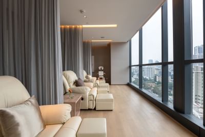 Sofas in Relax Spa with city view at Carlton Hotel Bangkok Sukhumvit