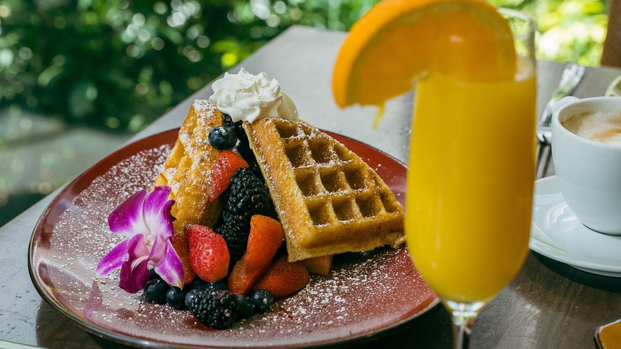Waffles, fruit, and orange juice for Mothers Day Brunch.