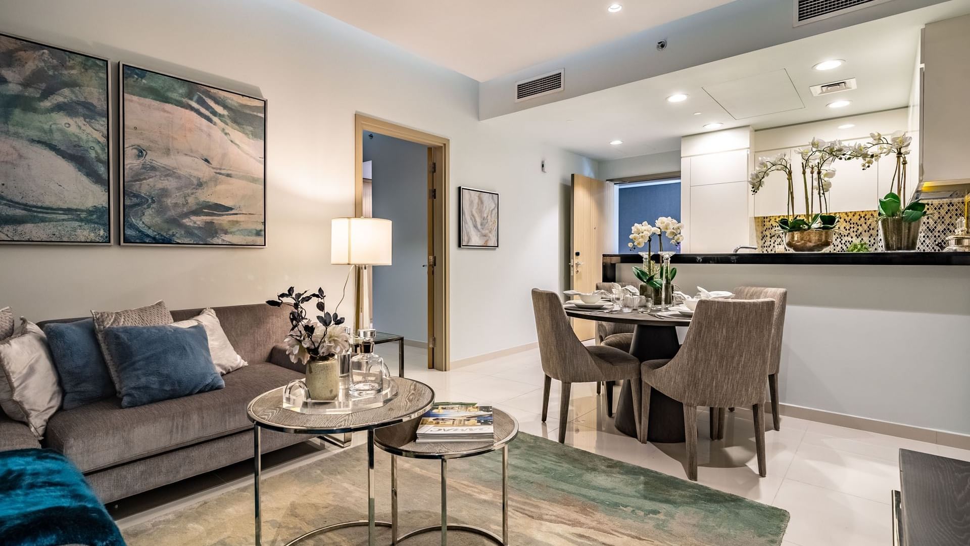 Cozy lounge area & dining table with an open kitchen in a Room at DAMAC Maison Aykon City Hotel Apartments