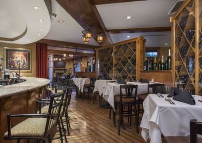 Ruth's Chris Steak House interior with setup tables and a wine display at Hotel Park City Autograph Collection 