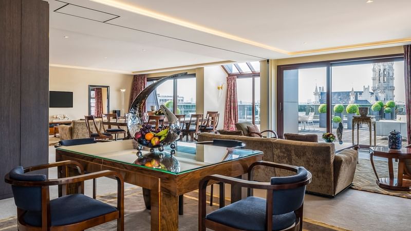 Dining and living area with city view in Grand Place Suite at Warwick Brussels