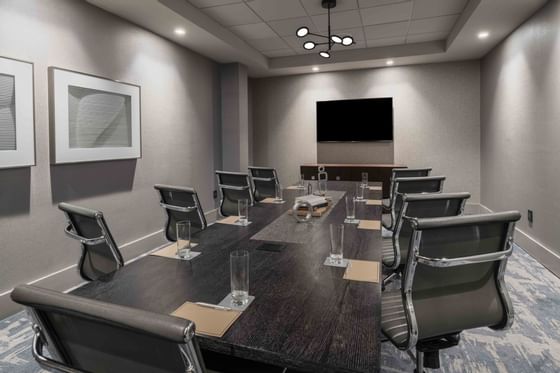 conference room with long table and television at the end