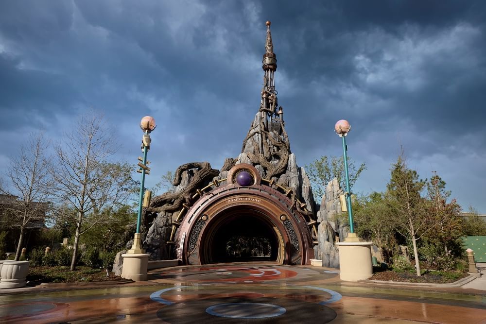 A creepy, craggy arched portal against a dark and stormy sky.