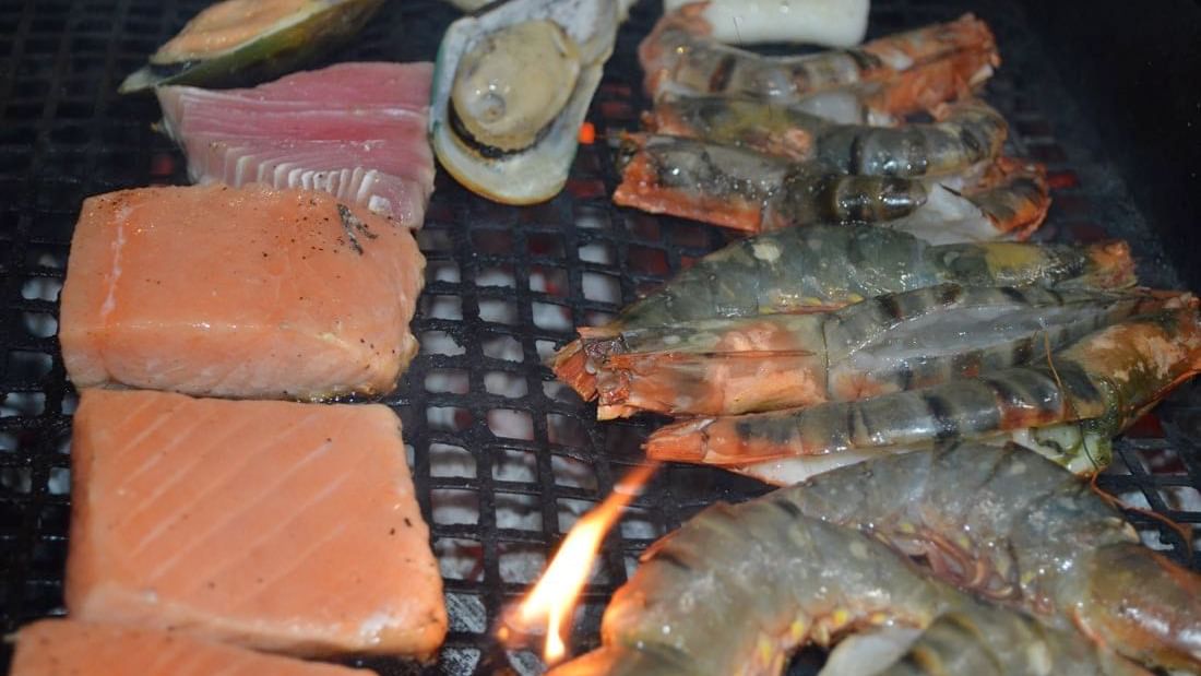 Close-up of the grill with assorted seafood on BBQ night at Warwick Doha