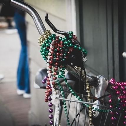 A bicycle decorated in colorful beaded necklaces in the streets