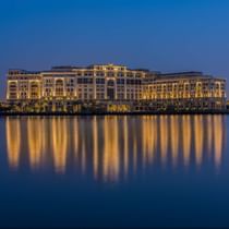 Exterior view of hotel by the river at night at Palazzo Versace