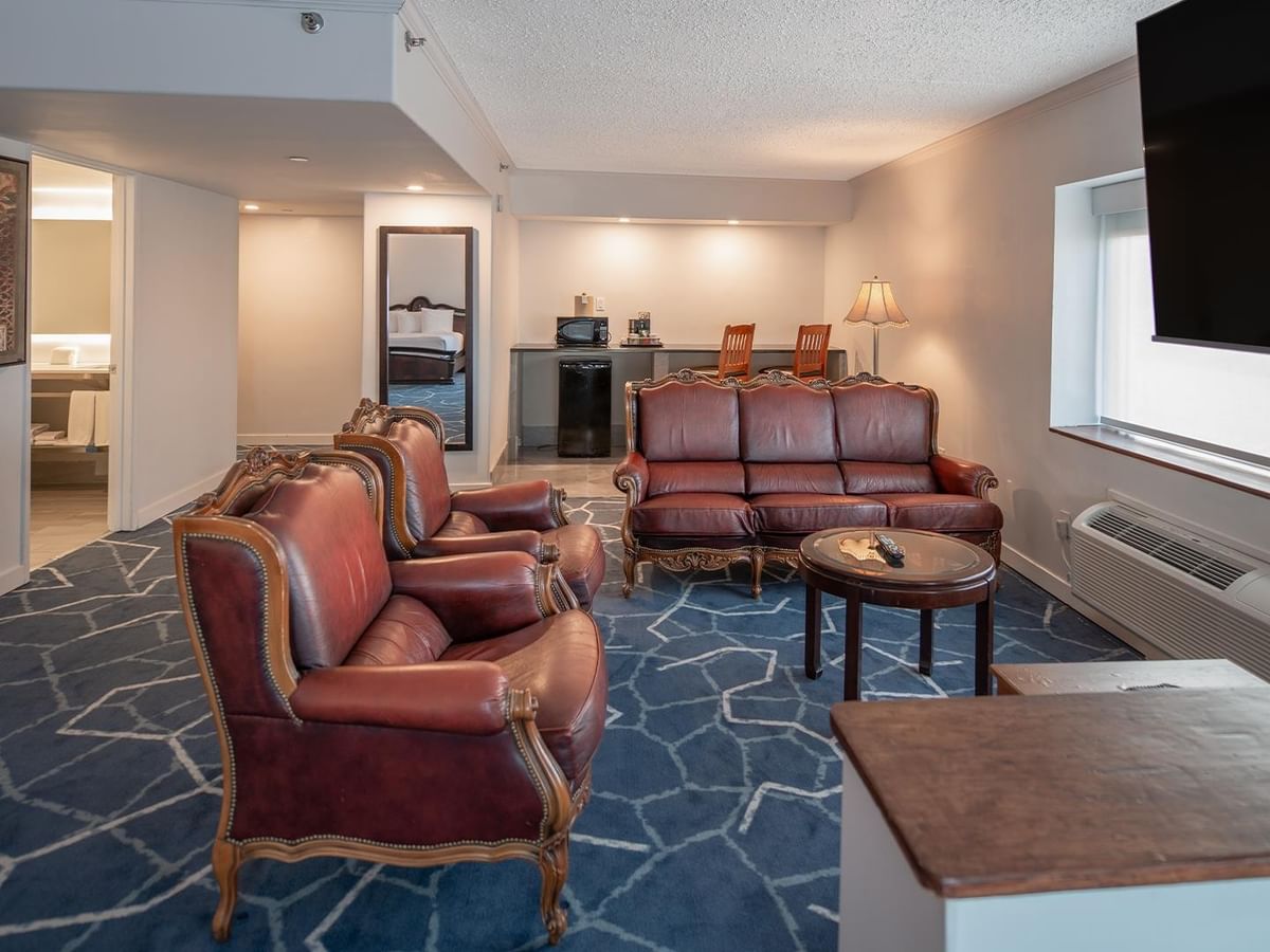 Elegant hotel suite with jetted tub and comfortable seating.