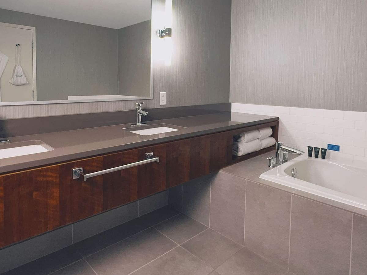 Modern bathroom with large mirror, sink, and bathtub