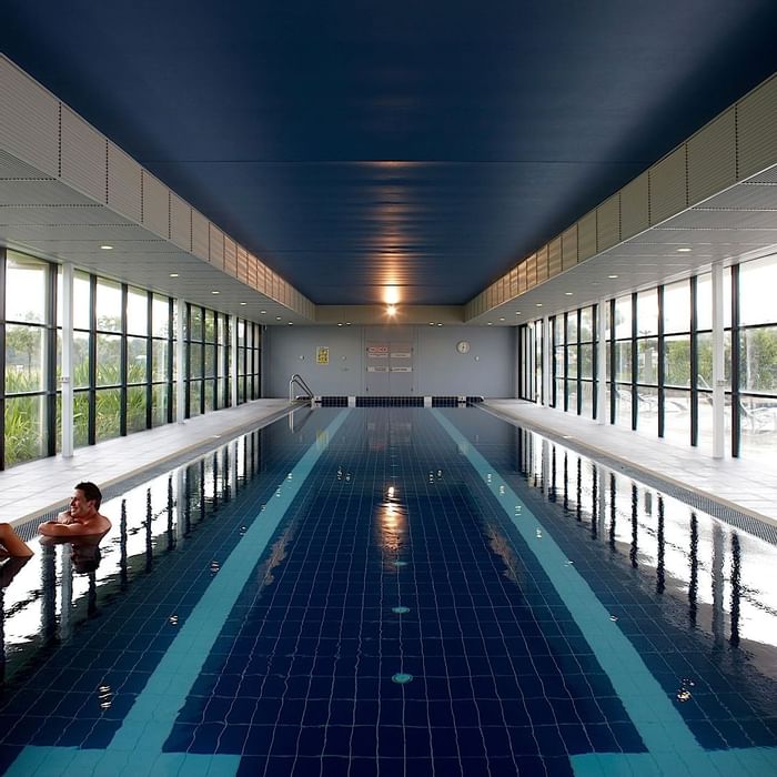 Two people at interior swimming pool in Mercure Kooindah Waters