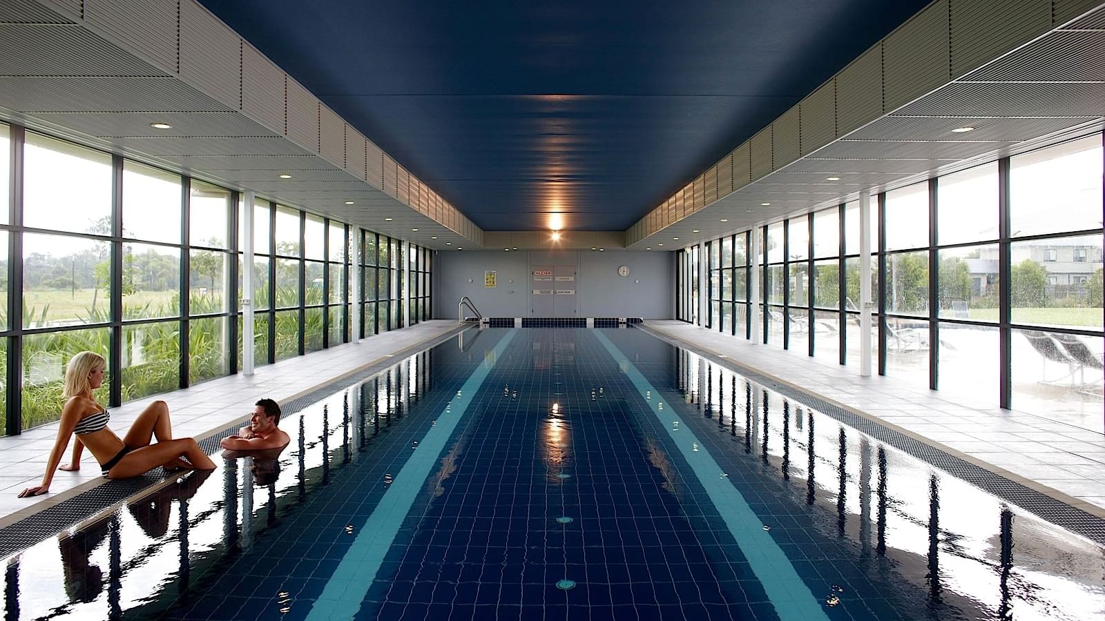 Two people at interior swimming pool in Mercure Kooindah Waters