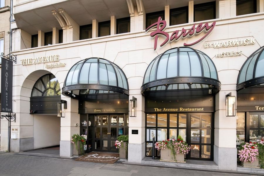 Grand stone facade with black glass awnings and 