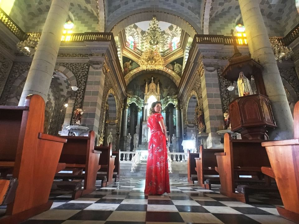 A women inside a catedral near Viaggio Resort Mazatlan